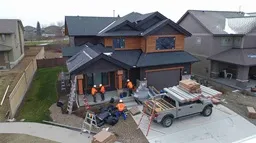 Excel Flat Roofing Professional roofer doing work on a residential home
